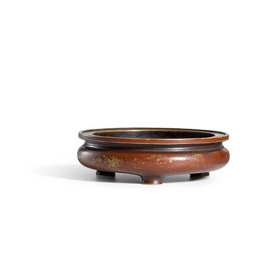 A BRONZE TRIPOD CENSER